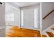Welcoming home foyer featuring hardwood floors, stairway and a solid wood front door at 6825 Castleton Dr, Atlanta, GA 30328