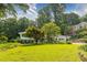 Classic home with a sprawling green lawn and mature trees, offering curb appeal at 6825 Castleton Dr, Atlanta, GA 30328
