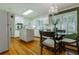 Traditional kitchen with white cabinets, hardwood floors, and a glass top breakfast table at 6825 Castleton Dr, Atlanta, GA 30328