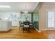 Charming kitchen featuring hardwood floors, an island, and a green accent wall in breakfast nook at 6825 Castleton Dr, Atlanta, GA 30328