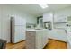 Traditional kitchen features hardwood floors, white cabinets, and stainless steel appliances at 6825 Castleton Dr, Atlanta, GA 30328