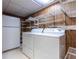 Convenient laundry room featuring side-by-side washer and dryer and shelving for storage at 6825 Castleton Dr, Atlanta, GA 30328