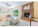 Bright living room featuring a brick fireplace, hardwood floors, shelving and slider to the backyard at 6825 Castleton Dr, Atlanta, GA 30328