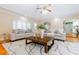 Inviting living room showcasing hardwood floors, neutral furnishings, and an open layout to the dining area at 6825 Castleton Dr, Atlanta, GA 30328