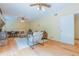Spacious living room featuring hardwood floors, a brick fireplace, comfortable seating, and ample natural light for relaxation at 6825 Castleton Dr, Atlanta, GA 30328