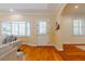 Bright living room features gleaming hardwood floors, crisp, neutral paint, and plantation blinds at 6825 Castleton Dr, Atlanta, GA 30328