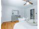 Bright primary bedroom with hardwood floors, a ceiling fan, and a gray dresser with mirror at 6825 Castleton Dr, Atlanta, GA 30328