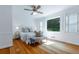 Bright primary bedroom with hardwood floors, a ceiling fan, and an abundance of light from the window at 6825 Castleton Dr, Atlanta, GA 30328