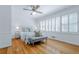 Bright primary bedroom with hardwood floors, a ceiling fan, and an abundance of light from the window at 6825 Castleton Dr, Atlanta, GA 30328