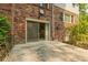 Brick home exterior featuring a concrete patio and sliding glass doors at 6825 Castleton Dr, Atlanta, GA 30328