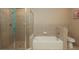 Bathroom showcasing a tiled shower with glass door and a relaxing tub at 711 Cosmopolitan Ne Dr # 338, Atlanta, GA 30324