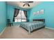 Bright bedroom with blue walls, carpet, and a cozy bed at 711 Cosmopolitan Ne Dr # 338, Atlanta, GA 30324