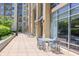 Outdoor patio area with tables and seating for residents in front of modern building at 711 Cosmopolitan Ne Dr # 338, Atlanta, GA 30324