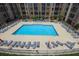 Aerial view of a pristine community pool with lounge chairs for relaxing by the water at 711 Cosmopolitan Ne Dr # 338, Atlanta, GA 30324
