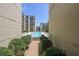 View of pool area landscaped with green plants in between buildings with modern architecture at 711 Cosmopolitan Ne Dr # 338, Atlanta, GA 30324