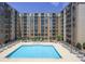 Resort-style pool surrounded by a modern building provides a luxurious living experience at 711 Cosmopolitan Ne Dr # 338, Atlanta, GA 30324