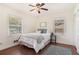 Bright bedroom with hardwood floors, two large windows, neutral decor, and a comfortable queen-sized bed at 2070 Brannen Se Rd, Atlanta, GA 30316