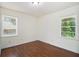 Empty bedroom showcasing hardwood floors and two windows allowing natural light at 2070 Brannen Se Rd, Atlanta, GA 30316
