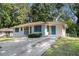Charming single-story home featuring a well-maintained lawn, updated with vibrant turquoise door and window shutter trim at 2070 Brannen Se Rd, Atlanta, GA 30316