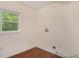 Laundry Room featuring a window, neutral paint, and hardwood floor at 2070 Brannen Se Rd, Atlanta, GA 30316