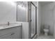 Modern bathroom featuring a patterned glass shower, white marble floors and a sleek vanity at 2323 Mason Dr # D21, Atlanta, GA 30316
