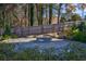 Stone firepit patio area surrounded by lush landscaping and a wooden fence at 2323 Mason Dr # D21, Atlanta, GA 30316