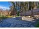 Outdoor stone firepit and patio area with surrounding greenery, creating a serene backyard space at 2323 Mason Dr # D21, Atlanta, GA 30316