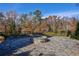 Landscaped backyard with a stone firepit and circular stone patio at 2323 Mason Dr # D21, Atlanta, GA 30316