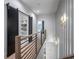 Upper hallway with a sliding barn door to the laundry and views of the lower staircase at 2323 Mason Dr # D21, Atlanta, GA 30316