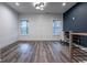 Bright upstairs landing area featuring a blue accent wall, and wood floors at 2323 Mason Dr # D21, Atlanta, GA 30316