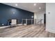 Upstairs landing area featuring a blue accent wall, desk, and wood floors at 2323 Mason Dr # D21, Atlanta, GA 30316