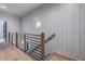 Hallway showcasing vertical paneling and a view of the staircase and landing at 2323 Mason Dr # D21, Atlanta, GA 30316