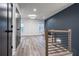 Upstairs hall with wood floors, blue accent wall, and modern railings at 2323 Mason Dr # D21, Atlanta, GA 30316