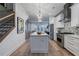 Modern kitchen with a white island, stainless appliances, wood floors, and modern light fixtures at 2323 Mason Dr # D21, Atlanta, GA 30316