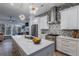 Modern kitchen featuring white cabinetry, stainless steel appliances, and a beautiful chevron tile backsplash at 2323 Mason Dr # D21, Atlanta, GA 30316