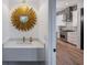 Stylish powder room with a decorative mirror and modern vanity next to a kitchen view at 2323 Mason Dr # D21, Atlanta, GA 30316