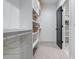 Spacious walk-in closet with white shelving, hanging rods, and decorative baskets at 2323 Mason Dr # D21, Atlanta, GA 30316