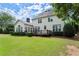 Spacious backyard with a large lawn, patio, and mature trees, perfect for relaxation and recreation at 3049 Brightwood Se Ln, Marietta, GA 30067