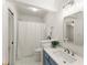 Stylish bathroom with blue vanity, modern fixtures, and shower with curtain at 3049 Brightwood Se Ln, Marietta, GA 30067