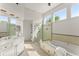 Luxurious bathroom featuring a soaking tub, a glass-enclosed shower, and natural light at 3049 Brightwood Se Ln, Marietta, GA 30067