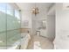 Elegant bathroom with a soaking tub, walk-in shower, and chandelier at 3049 Brightwood Se Ln, Marietta, GA 30067