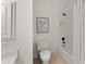 Bright bathroom with white fixtures, tile floor, and framed artwork provides a clean and modern design at 3049 Brightwood Se Ln, Marietta, GA 30067
