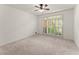 Bright bedroom with neutral carpet, white walls, and large window offering ample natural light at 3049 Brightwood Se Ln, Marietta, GA 30067