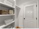 Organized closet boasts open shelving and a door, offering practical storage solutions and privacy at 3049 Brightwood Se Ln, Marietta, GA 30067