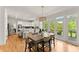 Bright dining area featuring hardwood floors, a wooden table, and open views to the kitchen and backyard at 3049 Brightwood Se Ln, Marietta, GA 30067