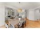 Open dining area with a wooden table and views of the staircase and living room with fireplace at 3049 Brightwood Se Ln, Marietta, GA 30067