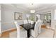 Elegant dining room with table set for six, decorative lighting, and a view into the adjacent office space at 3049 Brightwood Se Ln, Marietta, GA 30067