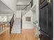 Bright foyer featuring a staircase with black metal railings, hardwood floors, and open access to the adjacent living room at 3049 Brightwood Se Ln, Marietta, GA 30067