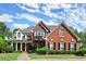 Charming two-story brick home with a manicured lawn, covered porch and mature landscaping at 3049 Brightwood Se Ln, Marietta, GA 30067