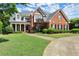 Two-story brick home with well-maintained lawn and a basketball hoop, complemented by charming landscaping and driveway at 3049 Brightwood Se Ln, Marietta, GA 30067